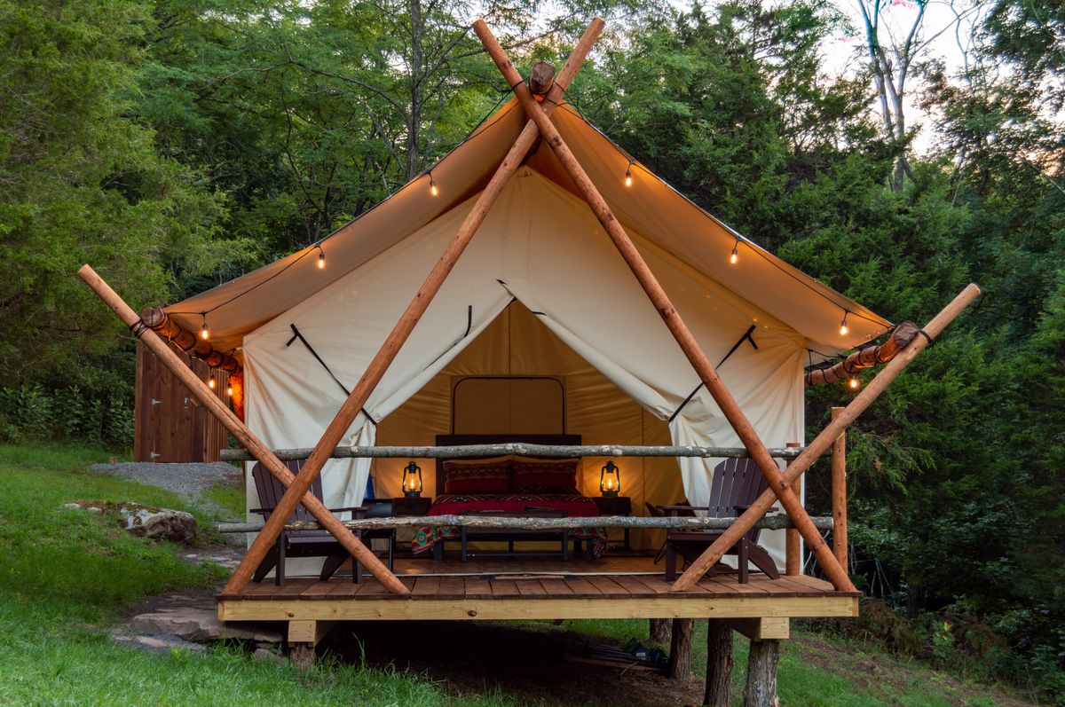 Luxury glamping tents at golden hour in nature — Glamping Village premium concept